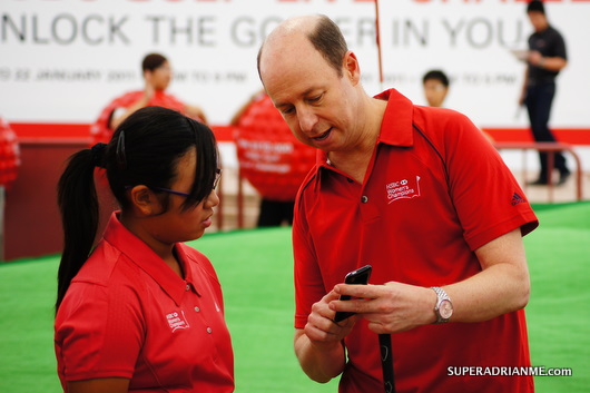 HSBC Golf 'Live' Championship - Darren Friedlander explains to 11 year old Amanda Tan of 0.2 handicap the iPhone application.