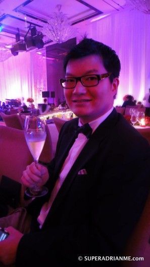 SUPERADRIANME with a glass of champagne