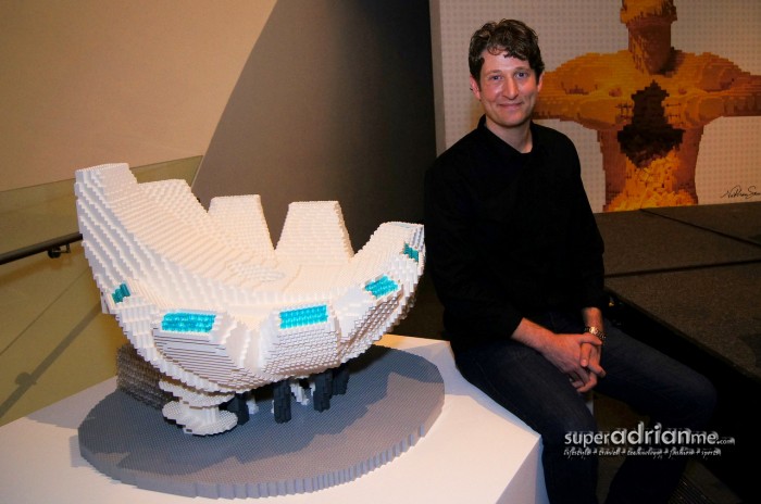 Artist Nathan Sawaya with his creation, the Art Science Museum LEGO sculpture